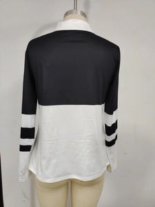 Detail of long sleeve polo shirt showing black and white striped design on breathable fabric