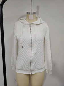 Detail of the white cable knit pattern and metal zipper on this hooded cardigan