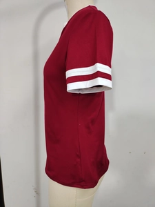 Detail of red athletic T-shirt featuring parallel white stripes and contrast neck binding