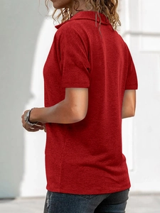 Close-up of the back view of a red textured knit polo shirt with lapel collar