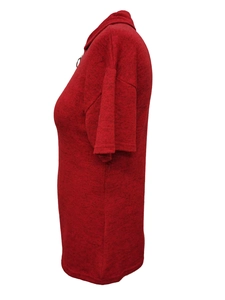 Detail view of red knitted polo shirt with textured fabric and zip-up collar