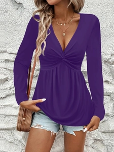 Detail of deep purple V-neck long sleeve top with twist knot front and peplum hem design