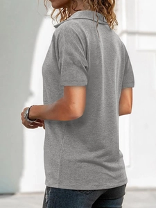 Close-up side view of grey knitted polo shirt showing fabric texture and lapel zipper detail