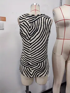 Detail view of women's sleeveless slim fit top with bold black and white zebra print pattern
