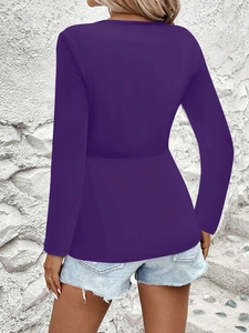 Back view of a slim fit purple long sleeve top with a feminine peplum waist design