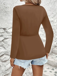 Back view of a coffee brown long sleeve peplum top with waist tie detail for women