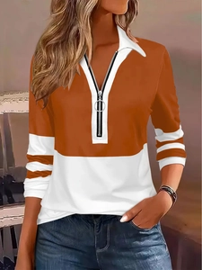 Detail of long sleeve polo shirt with orange stripes and silver ring zipper puller