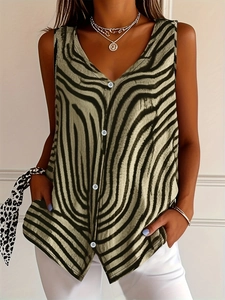Detail of V-neck zebra print sleeveless shirt showing white buttons and khaki fabric