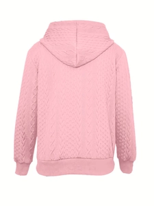 Detail view of pink cable-knit hoodie showing the soft fabric texture and ribbed hem