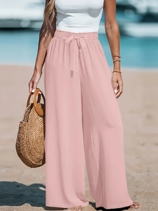 Eleganti pantaloni rosa a gamba larga in lino a vita alta con cintura a fiocco per spiaggia