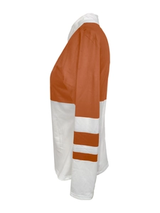 Detail view of the side profile on a long-sleeve color-block shirt in orange and white