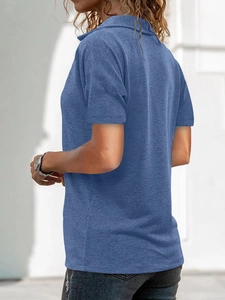 Close-up of blue knit polo shirt with waffle texture and casual collar detail