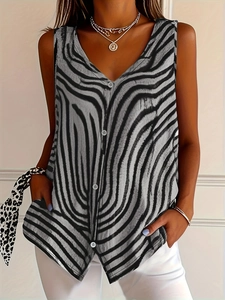 Detail of V-neck sleeveless top featuring bold zebra print and asymmetrical buttoned hem