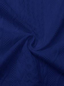 Close-up of navy blue knit fabric with honeycomb and diamond braided patterns
