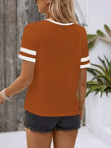 Detail of orange short-sleeve T-shirt with white striped sleeves and crew neck