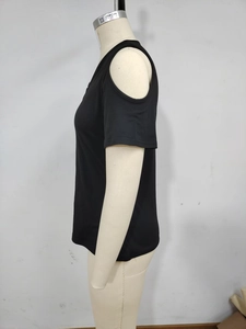 Detail view of the black cold-shoulder sleeve design on a relaxed V-neck T-shirt