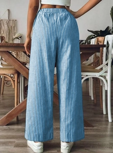 Detail of high waist elastic waistband on blue and white striped wide-leg trousers