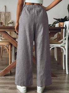 Detail of high-waisted grey striped wide-leg trousers showing elastic waistband and fabric
