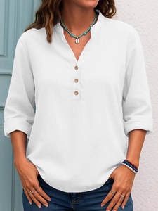Women casual white long sleeve V-neck blouse with wooden buttons in a natural outdoor setting