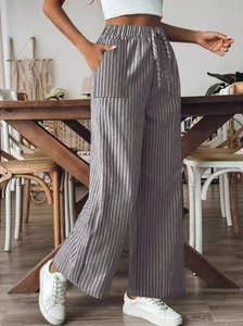 Detailed view of elastic waistband and drawstring on grey striped wide-leg trousers