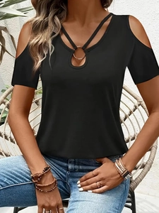 Detail of black cold shoulder top featuring a gold metal ring and teardrop cutout design