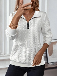 Detailed cable knit pattern on white quarter-zip sweatshirt with a front kangaroo pocket