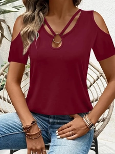 Detail of burgundy off-shoulder T-shirt with cross strap and metal ring neck decoration