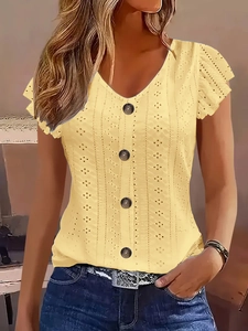 Detail of light yellow eyelet embroidery blouse with V-neckline and ruffled short sleeves