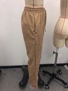 Detail of khaki corduroy pants showing elastic waistband with drawstring and side pockets