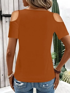 Back view of caramel orange cold shoulder T-shirt with bright outdoor background