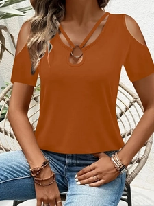 Detail of the V-neck hollow design with a metal ring on a caramel off-shoulder T-shirt