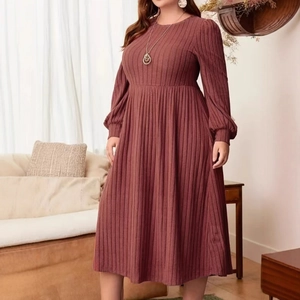 Close-up of dark brick red ribbed knit fabric on a long sleeve A-line casual dress
