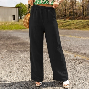 Detail of black cotton linen wide-leg pants with elastic drawstring waist and loose fit