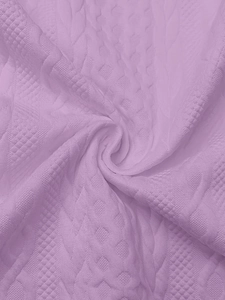 Detail of light purple knit hoodie fabric with cable patterns and waffle textures