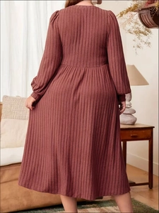 Detailed back view of a reddish-brown ribbed knit dress with textured vertical lines