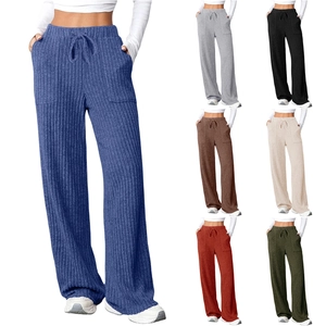 Detail of ribbed knit fabric texture and functional side pockets on these wide leg trousers