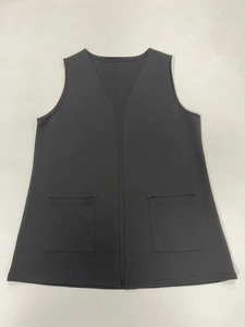 Close-up of deep gray sleeveless vest with classic V-neck and symmetrical square pockets