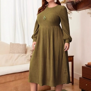 Detailed texture of olive green ribbed knit long sleeve dress with waist tie on model