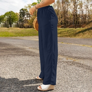 Detail view of dark blue wide-leg linen pants with elastic waist and side pockets