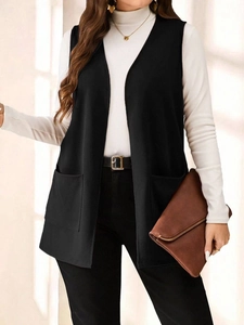 Close-up of black longline sleeveless vest featuring dual front square utility pockets