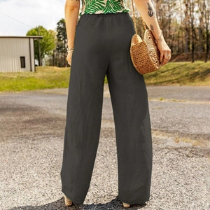 Detail of dark gray wide-leg cotton linen trousers with elastic waist and relaxed fit