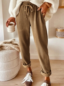 Women's casual corduroy drawstring pants in brown features side pockets and cuffed hem