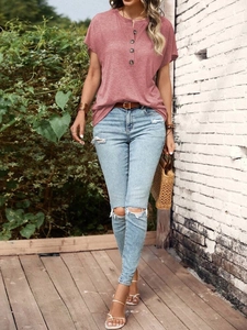 Detail of dusty rose Henley neck t-shirt with button accents and soft textured fabric