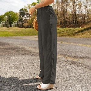 Detailed outdoor shot of dark grey high-waisted cotton linen wide leg pants with side pockets
