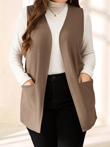 Detail view of a long brown sleeveless vest with large pockets and high-quality fabric texture