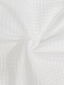 Detail shot showing the soft white waffle weave texture and premium knitted fabric pattern