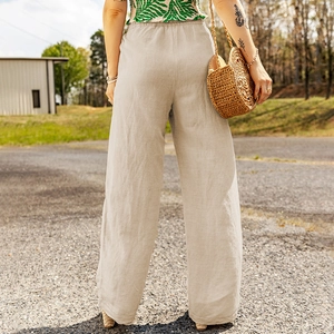 Back view of high-waisted linen wide-leg pants in beige with natural fabric texture