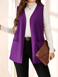 Detail view of a long dark purple sleeveless vest with two large front patch pockets