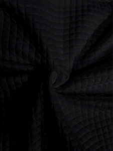 Close-up of black waffle textured quilted fabric showing diamond pattern and thickness