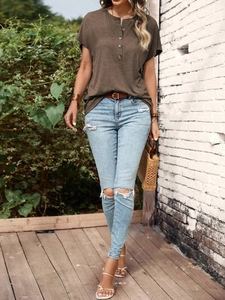 Close-up of brown Henley T-shirt with button neckline and casual ribbed texture fabric